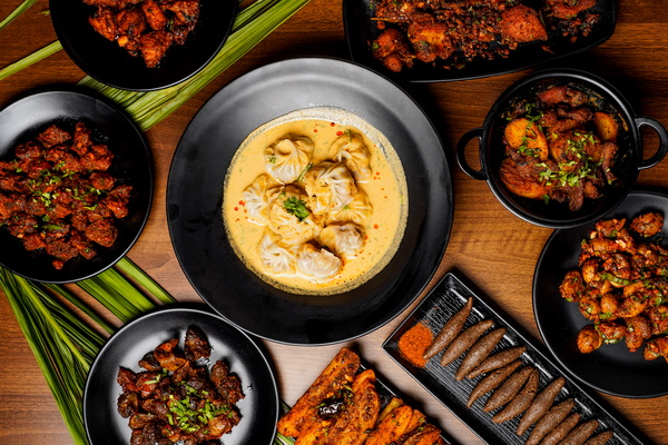 Full spread of Mustang Thakali dishes including jhol momo